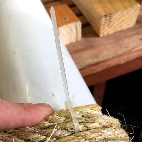 Zip-tying sisal segments to build a cat tree